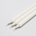 Close-up of white straight pillar candles