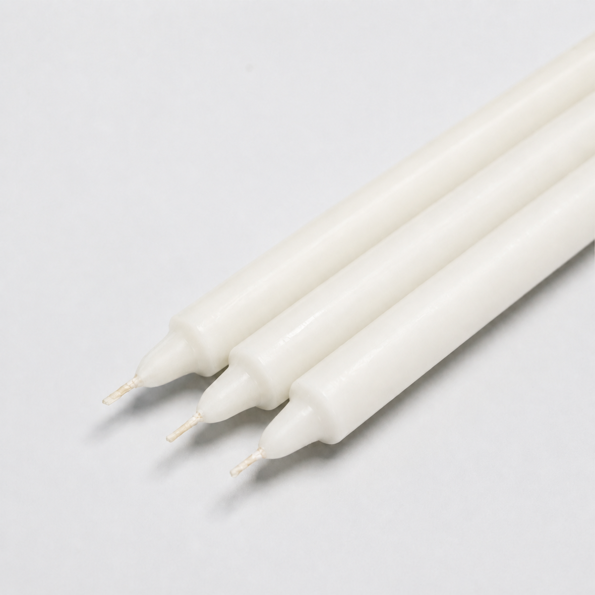 Close-up of white straight pillar candles
