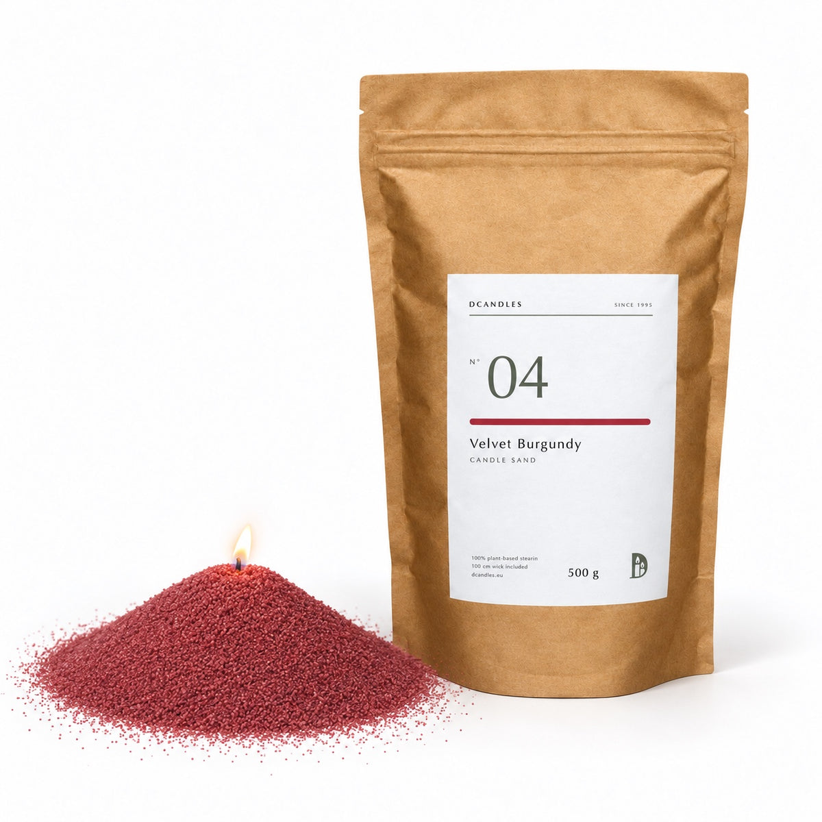 Candle sand N° 04 Velvet Burgundy, lit, next to its kraft bag