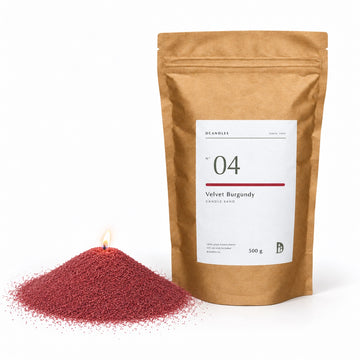Candle sand N° 04 Velvet Burgundy, lit, next to its kraft bag