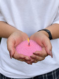 Candle sand N° 05 Rose Quartz burning in cupped hands