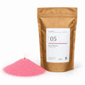 Candle sand N° 05 Rose Quartz, lit, next to its kraft bag