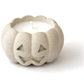 White concrete jack-o'-lantern candle, close-up