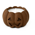 Brown concrete jack-o'-lantern candle, close-up