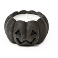 Graphite concrete jack-o'-lantern candle, close-up