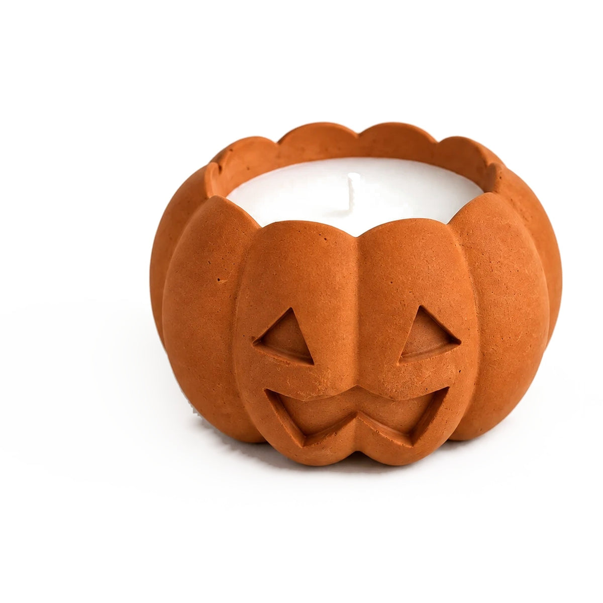 Orange concrete jack-o'-lantern candle, close-up