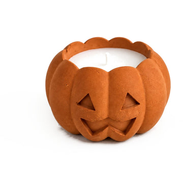 Orange concrete jack-o'-lantern candle, close-up