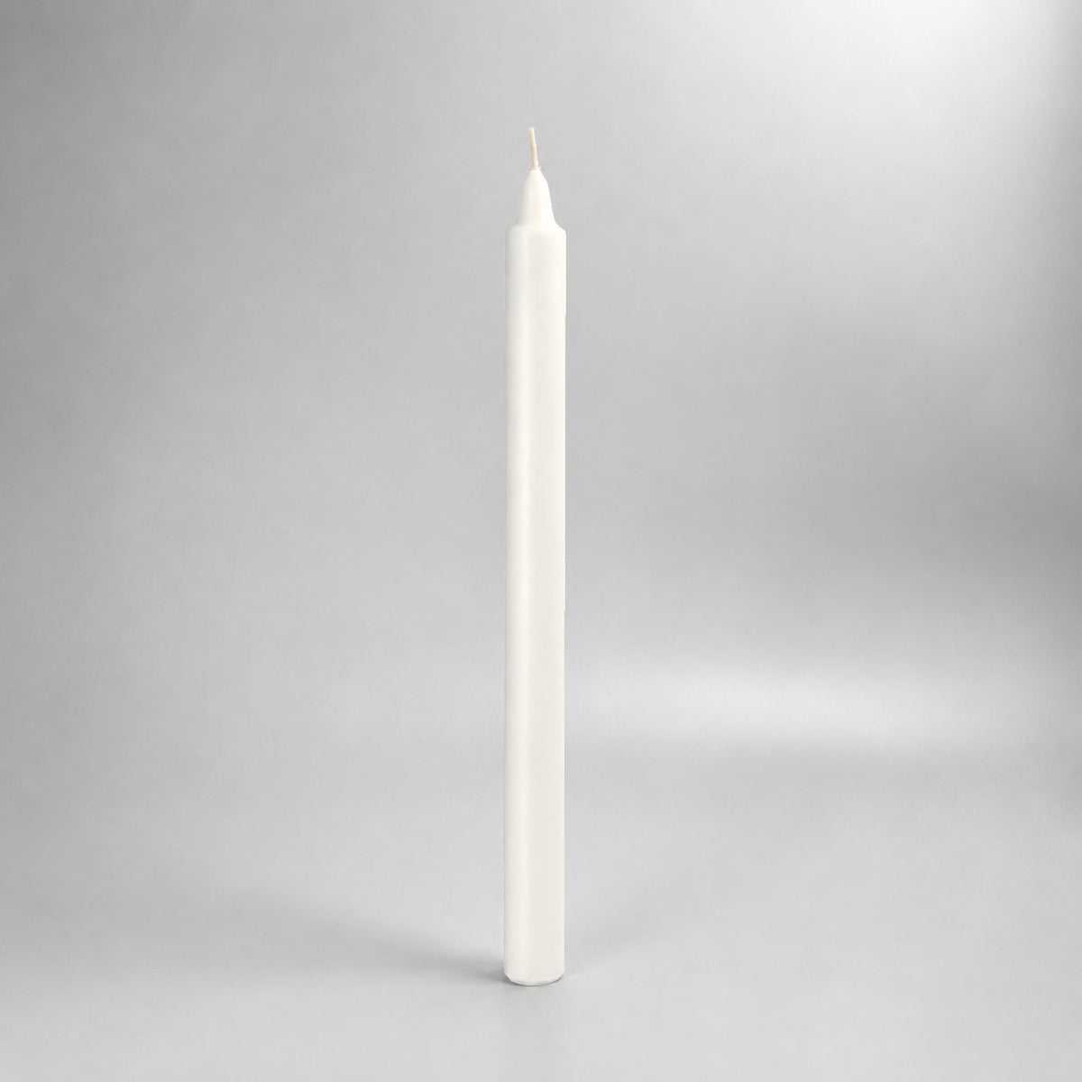White straight wax pillar candle, studio view